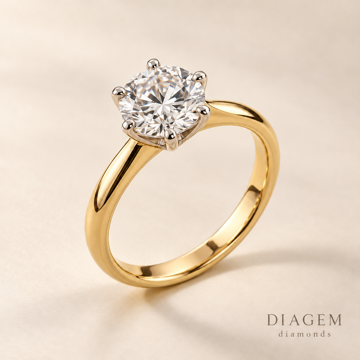 Round diamond solitaire engagement ring with a yellow-gold band