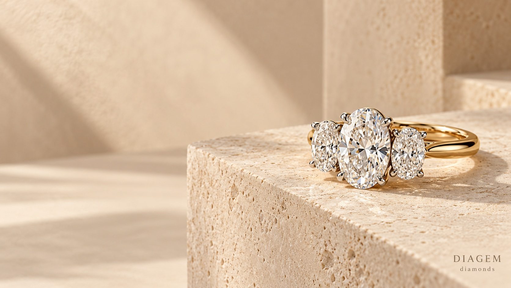 Three-stone diamond engagement ring on a stone plinth